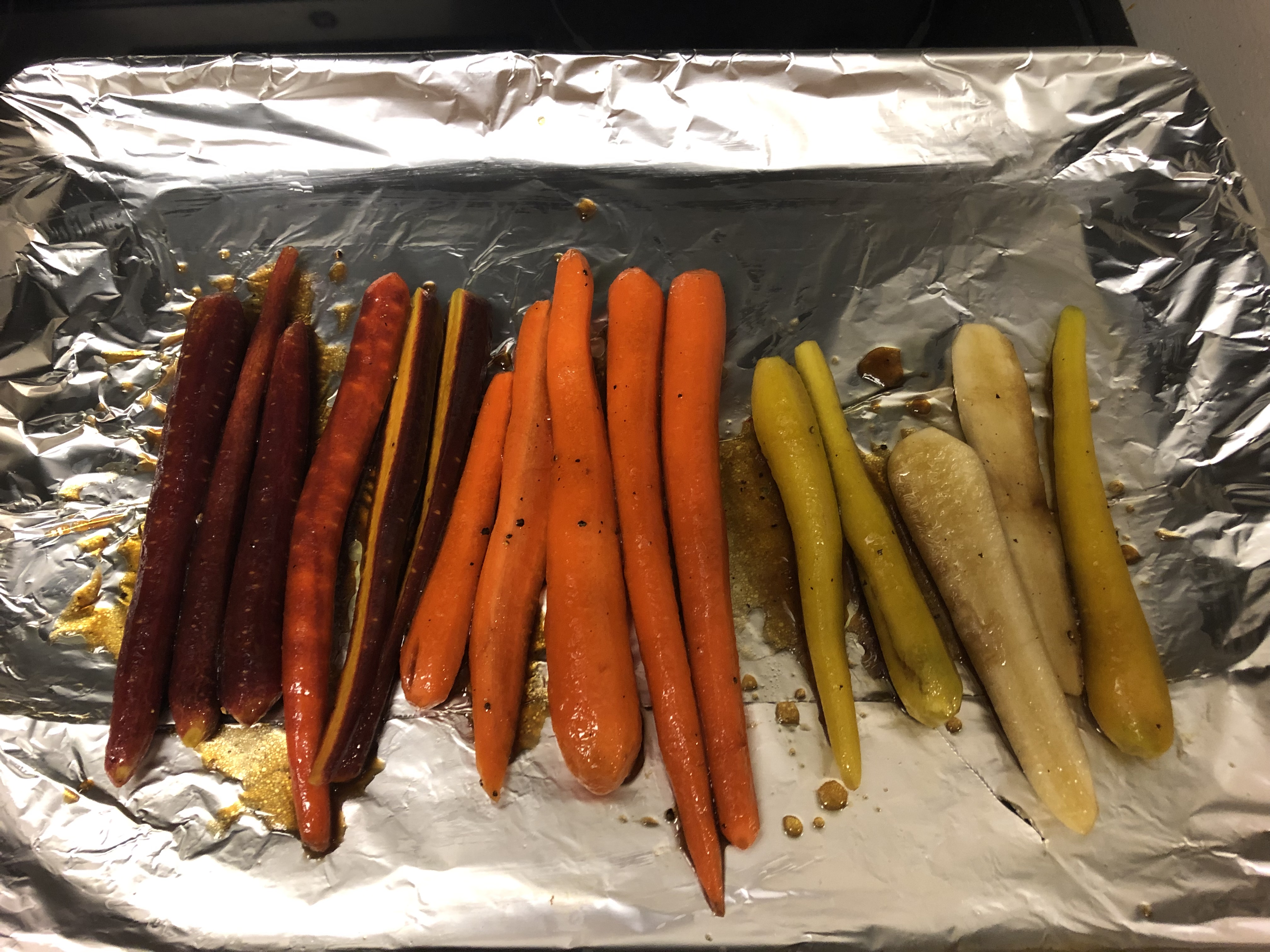 Carrots on baking sheet covered with mixture