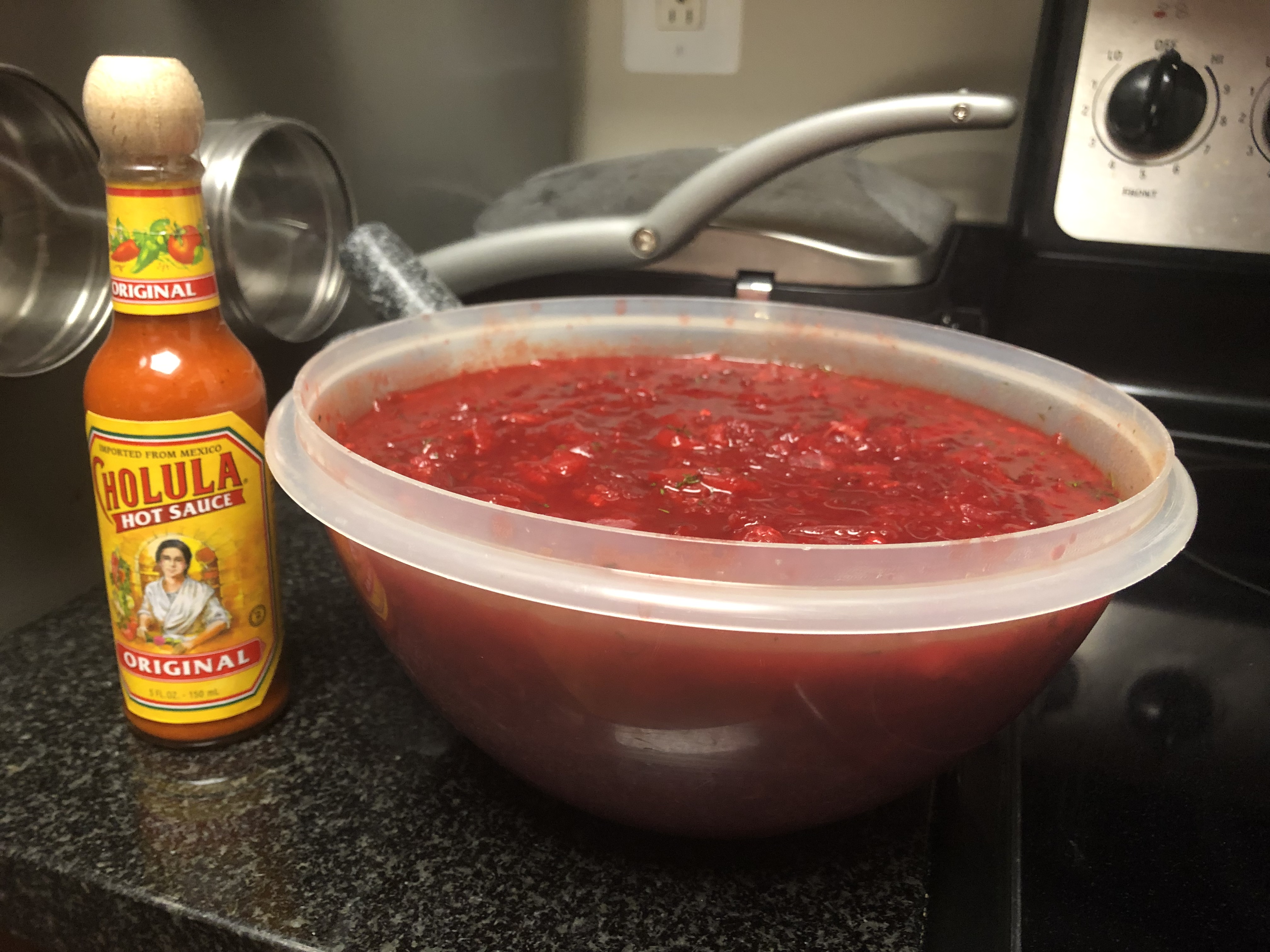 Leftovers filling extra large tupperware container, Cholula bottle for scale