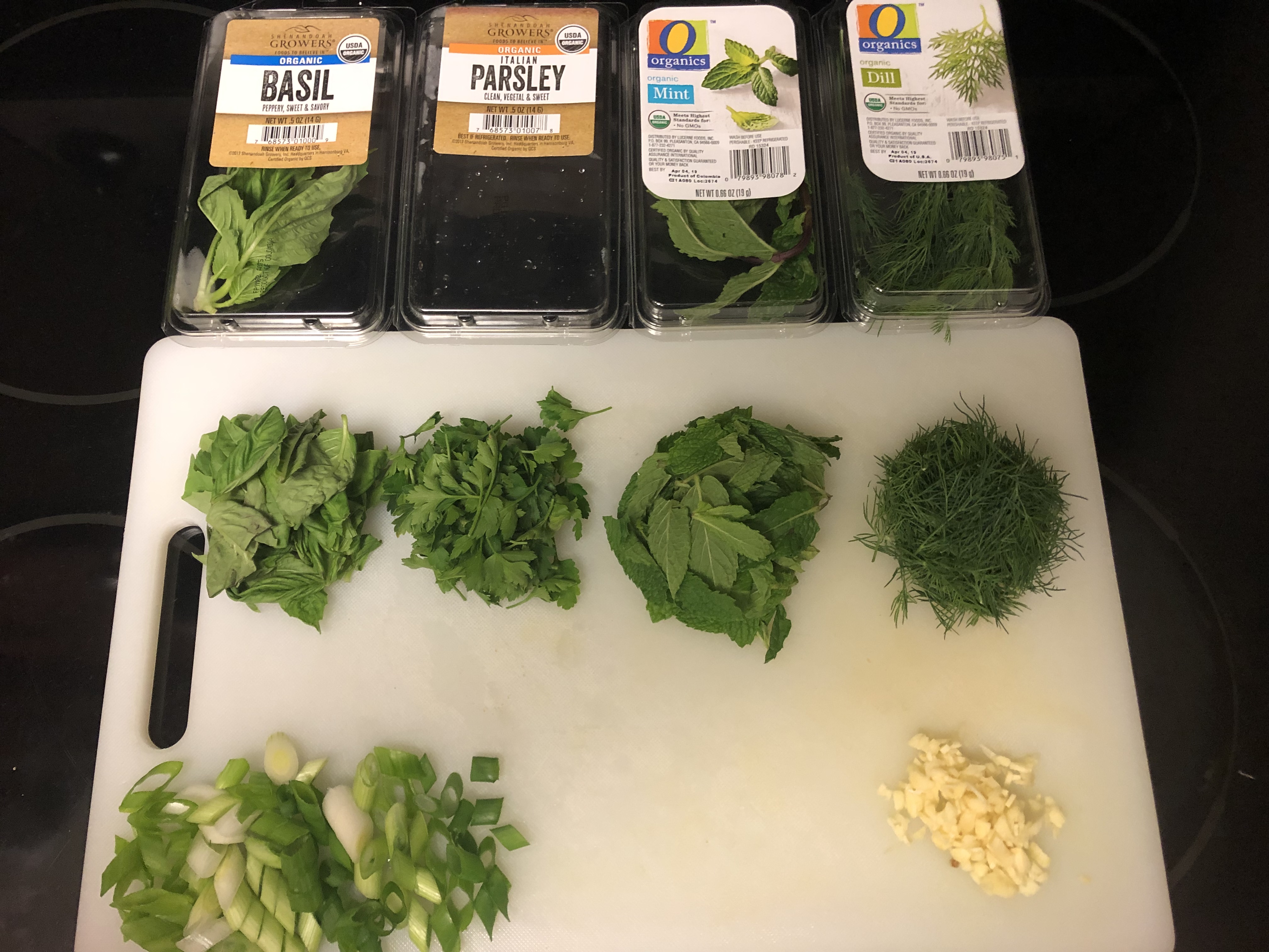 Ingredients prepped on cutting board with ingredients in front of their respective packages for labeling