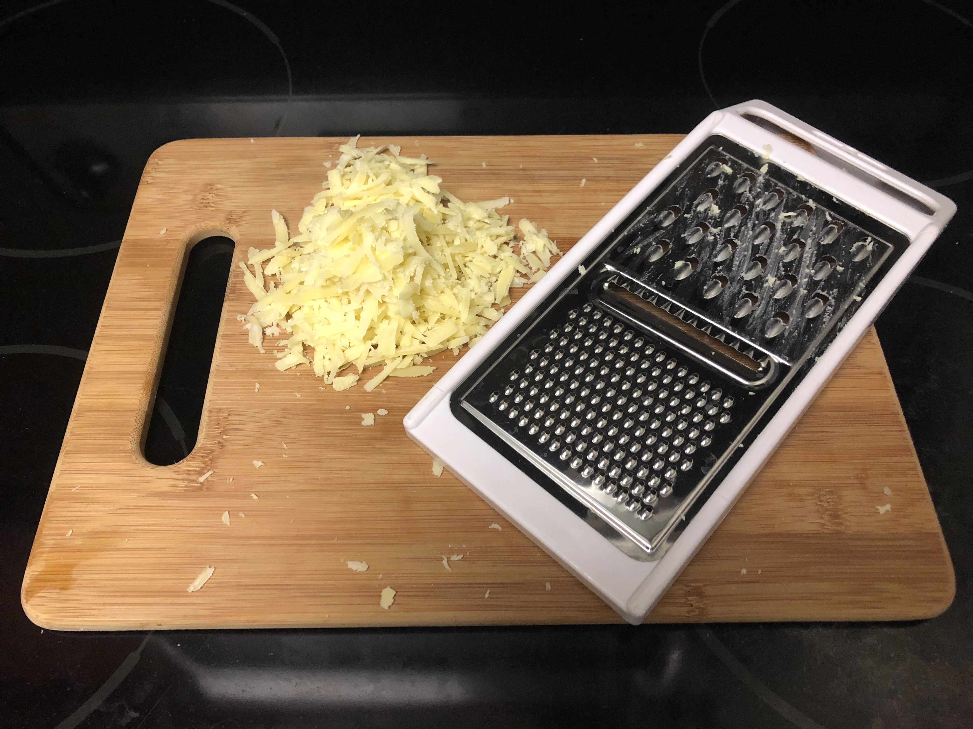 Grated cheese on cutting board