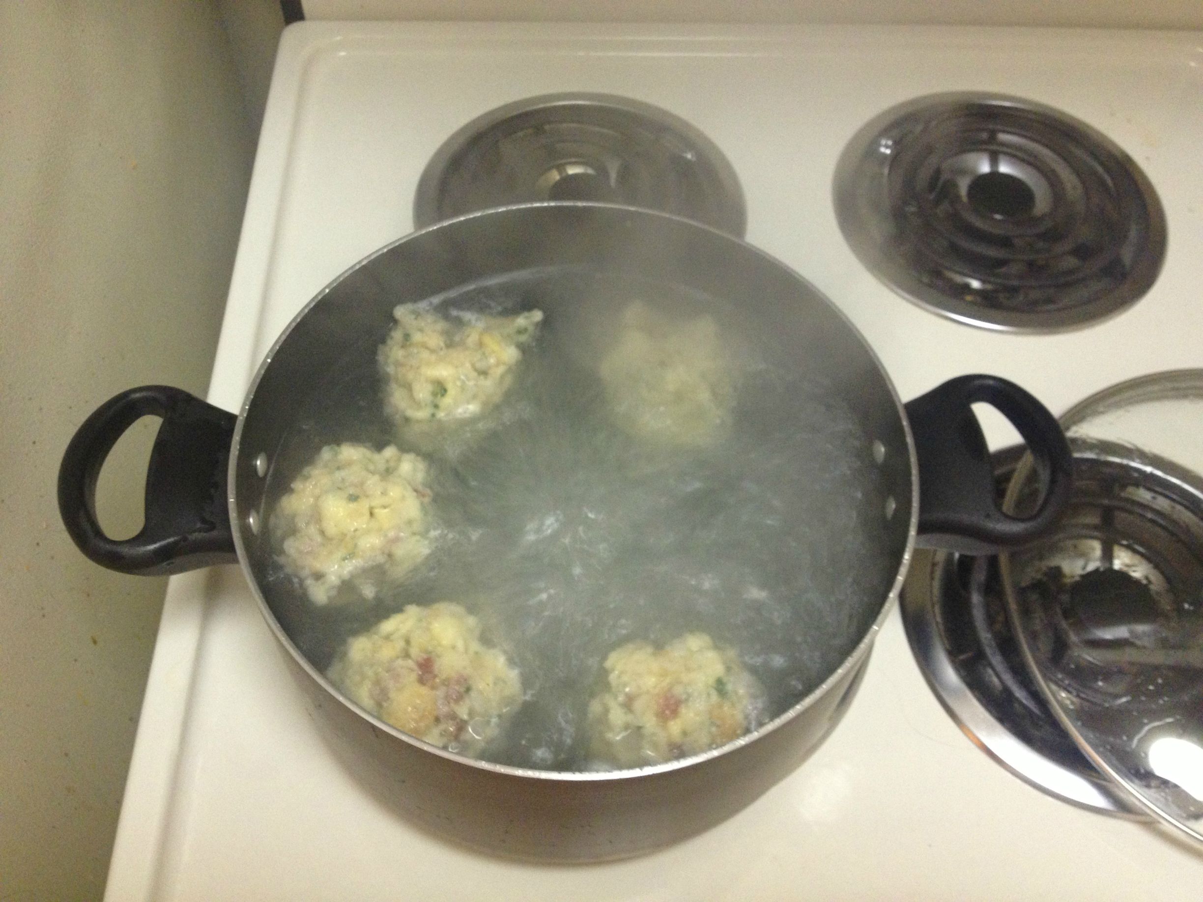 Knodels in pot with boiling water