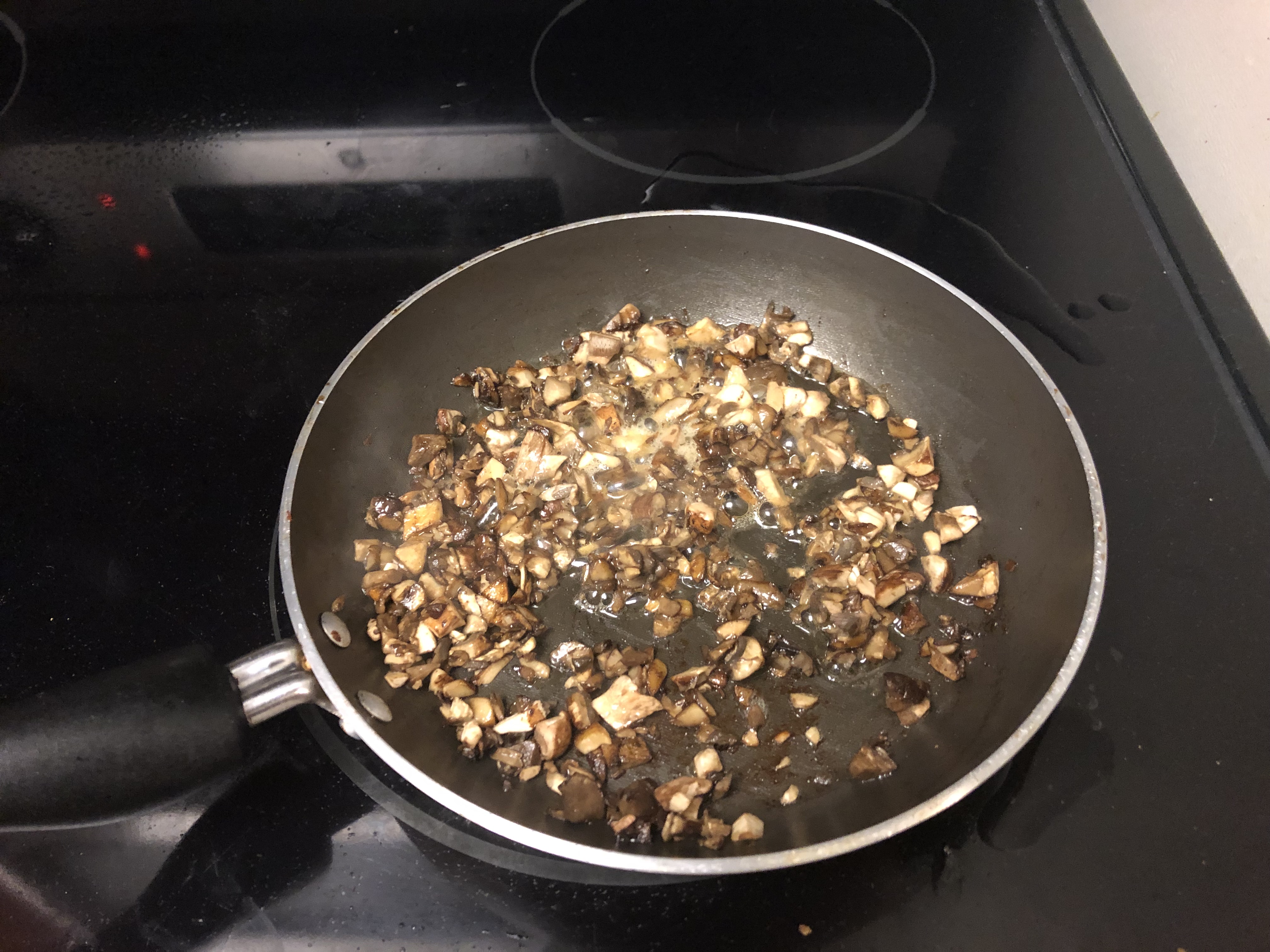 Mushrooms cooking in pan